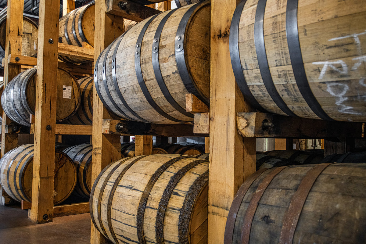 Whiskey barrels ageing in the rickhouse at Ty Iechyd Da Distillery